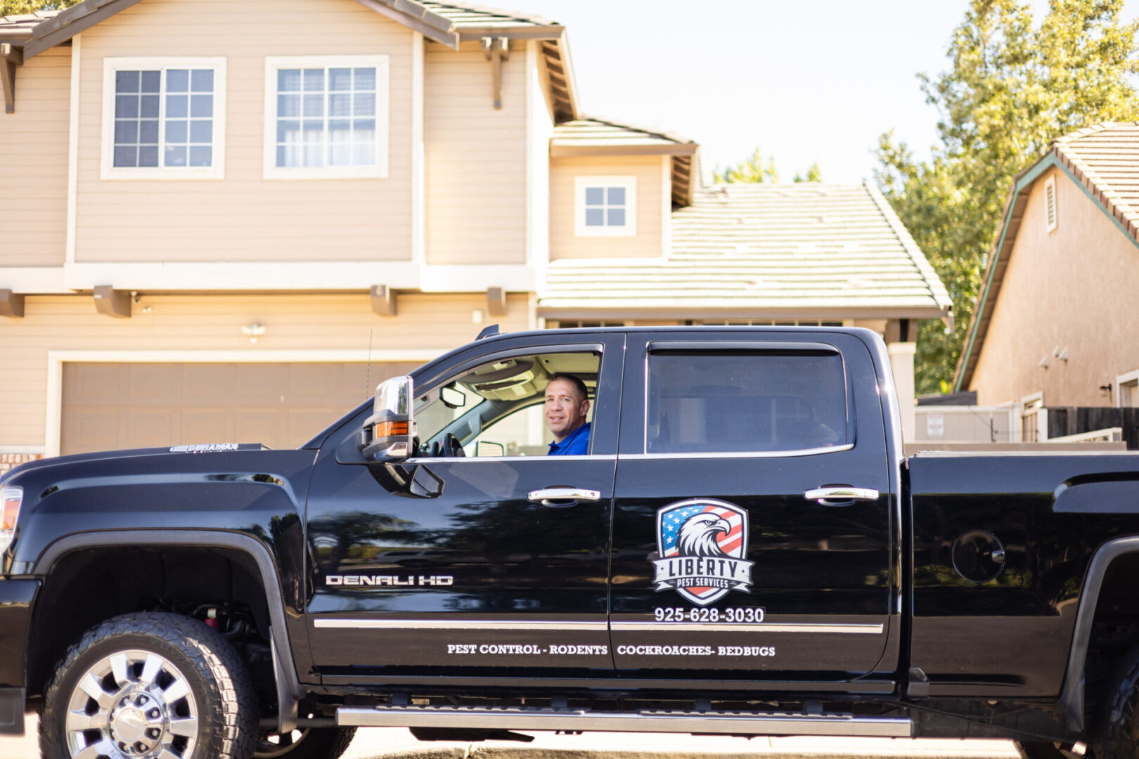 A man driving in the back of a black truck.