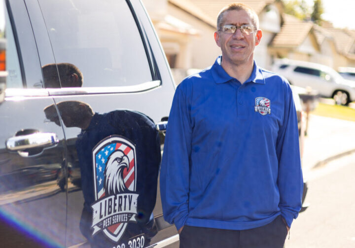 A man standing in front of a car.